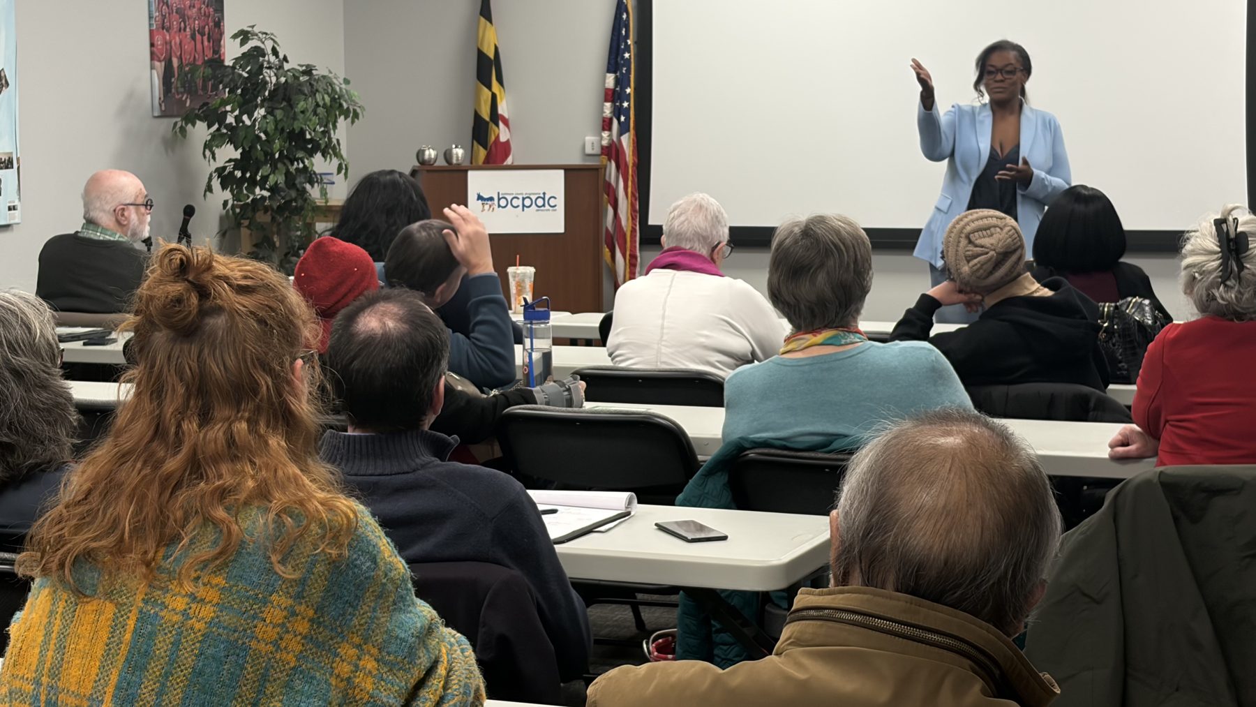 Randi White speaking at a community meeting
