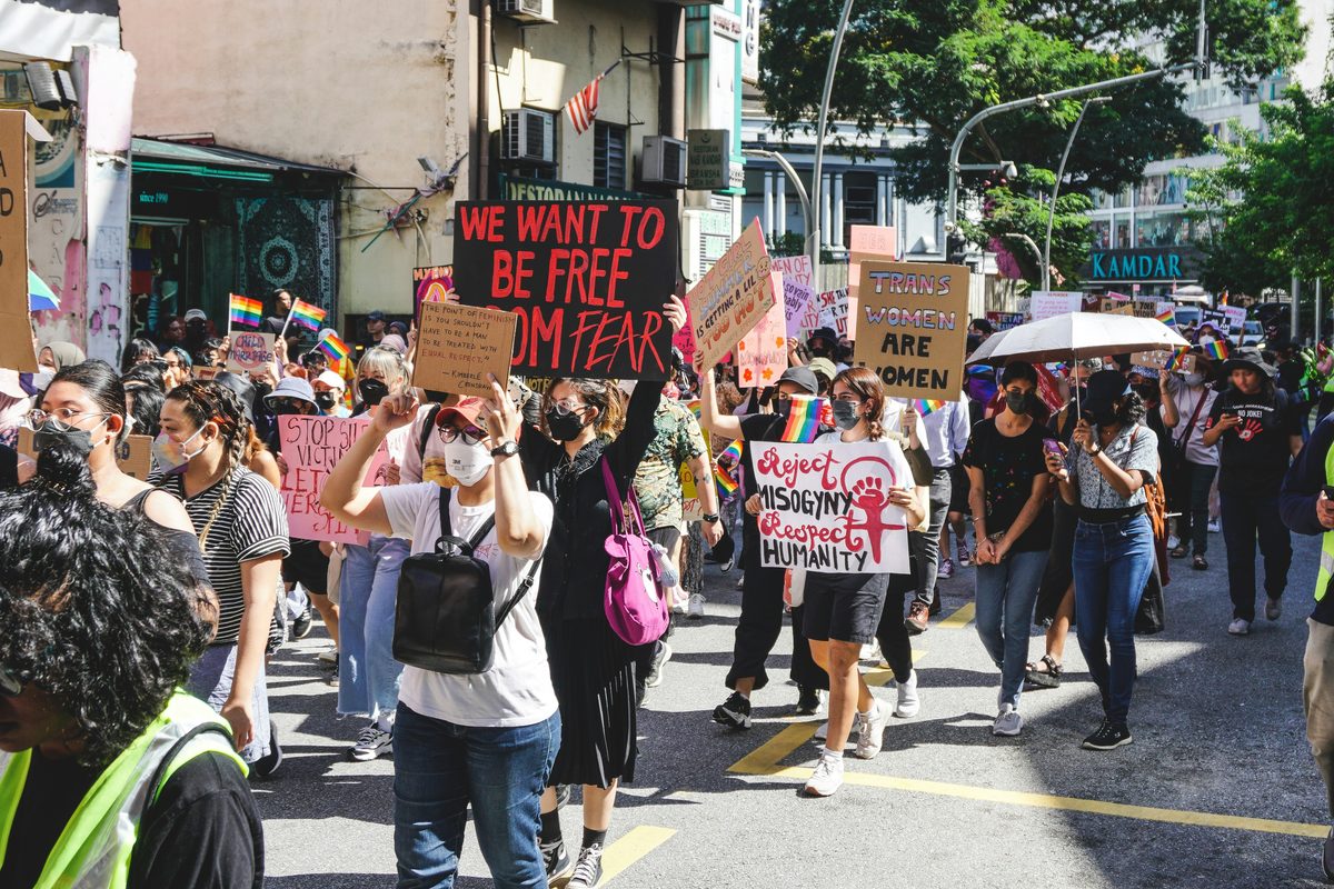 Demonstrators with placards and Pride flags