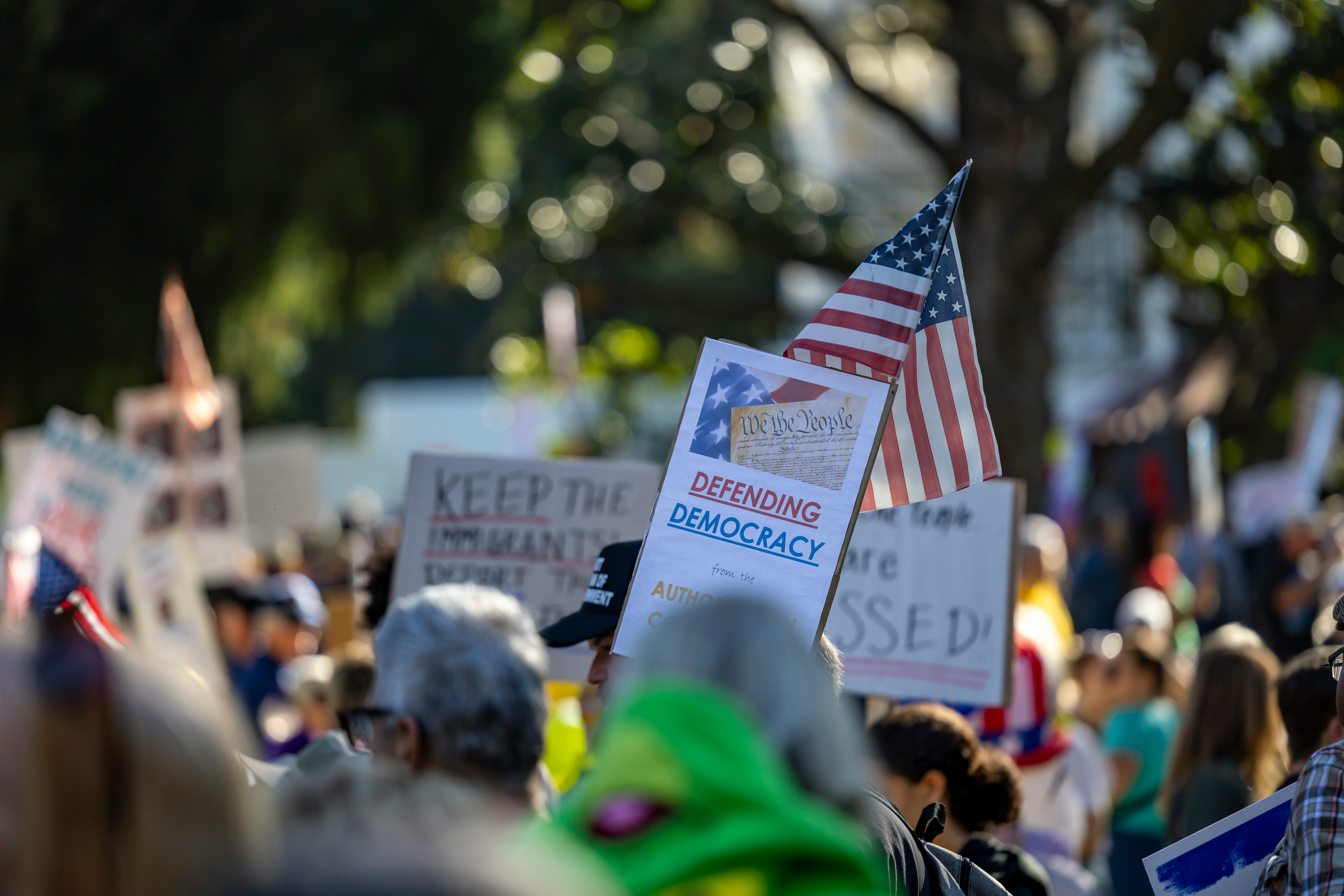 People gathered at a rally with American flags